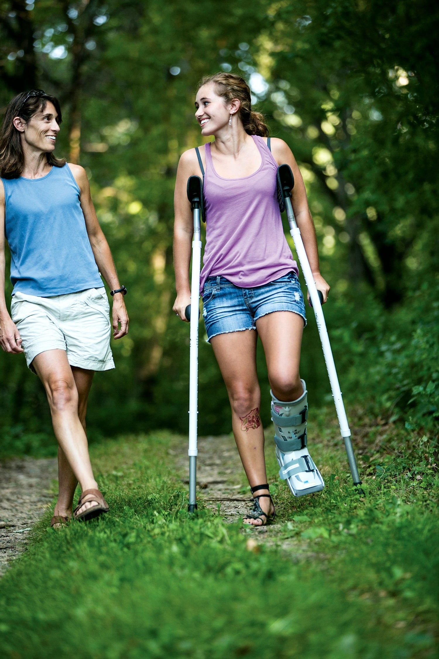 A Mobilegs user walking outdoors with a companion