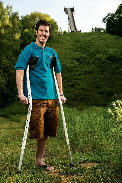 A long-term Mobilegs user standing outdoors with his Ultra crutches